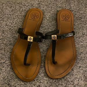 Black Tory Burch thong sandal with bow and gold detailing, size 8
